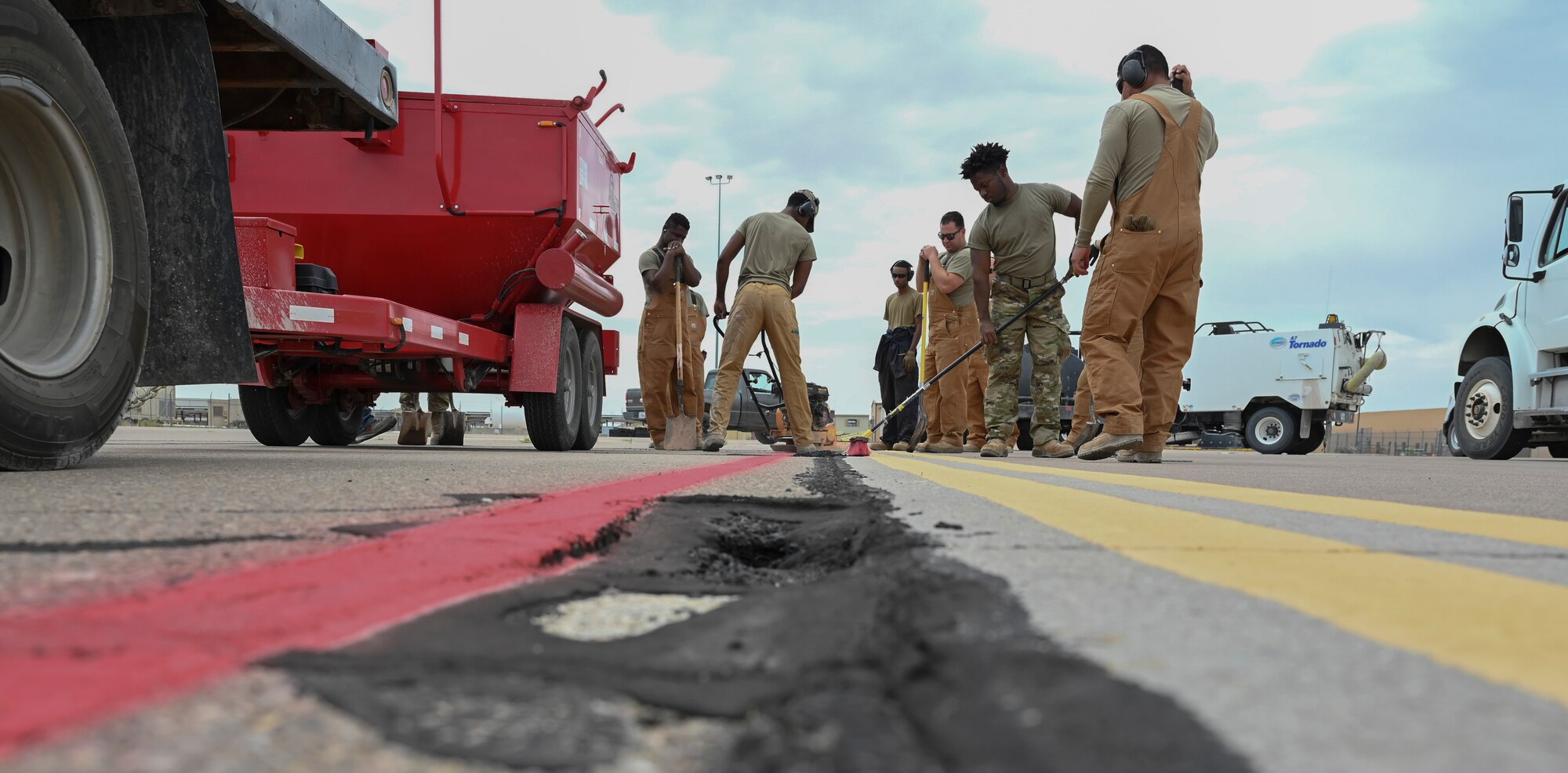 Airmen from the 49th Civil Engineer Squadron perform airway pavement repair at Holloman Air Force Base, New Mexico, June 30, 2023. The 49th CES pavement and construction Airmen are often referred to as “Dirt Boyz” for their constant interaction with various heavy construction equipment and hand tools used to repair and maintain Holloman’s roads, airfields, fences and drainage systems. (U.S. Air Force photo by Airman 1st Class Michelle Ferrari)