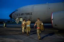 airmen walk to plane