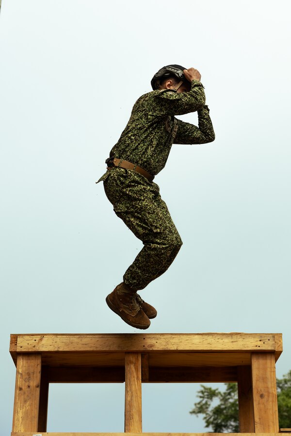 A Colombian reconnaissance Marine demonstrates proper jumping form during low level static line training for UNITAS LXIV at Cartagena, Colombia, July 17, 2023. During UNITAS, reconnaissance and special operation force Marines from partner and allied nations conducted multilateral special operations training consisting of room clearing, visit board search and seizure, jungle patrolling, low level static line jumping, small arms, and helicopter rope suspension tactics. UNITAS, hosted by Colombia this year, is the world’s longest-running annual multinational maritime exercise that focuses on enhancing interoperability among multiple nations and joint forces during littoral and amphibious operations in order to build on existing regional partnerships and create new enduring relationships that promote peace, stability, and prosperity in the U.S. Southern Command’s area of responsibility. (U.S. Marine Corps photo by Sgt. Colton K. Garrett)