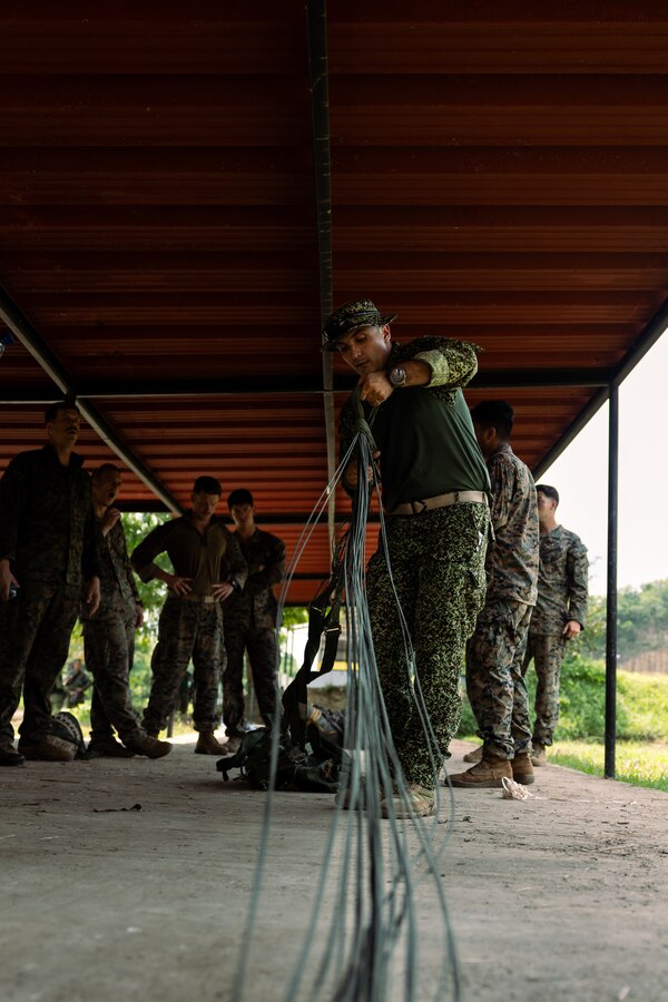 A Colombian reconnaissance Marine demonstrates parachute recovery during low level static line training for UNITAS LXIV at Cartagena, Colombia, July 17, 2023. During UNITAS, reconnaissance and special operation force Marines from partner and allied nations conducted multilateral special operations training consisting of room clearing, visit board search and seizure, jungle patrolling, low level static line jumping, small arms, and helicopter rope suspension tactics. UNITAS, hosted by Colombia this year, is the world’s longest-running annual multinational maritime exercise that focuses on enhancing interoperability among multiple nations and joint forces during littoral and amphibious operations in order to build on existing regional partnerships and create new enduring relationships that promote peace, stability, and prosperity in the U.S. Southern Command’s area of responsibility. (U.S. Marine Corps photo by Sgt. Colton K. Garrett)