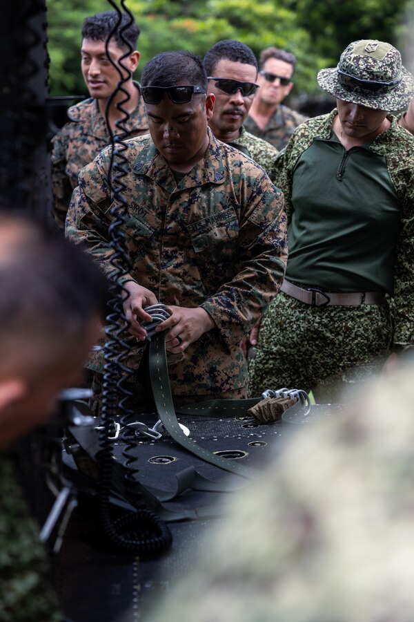 U.S. Marine Corps Sgt. Francis Sirot, a parachute rigger with 4th reconnaissance Battalion, 4th Marine Division, rigs an anchor line to a U.S. Marine Corps UH-1Y Venom during low level static line training for UNITAS LXIV at Cartagena, Colombia, July 17, 2023. During UNITAS, reconnaissance and special operation force Marines from partner and allied nations conducted multilateral special operations training consisting of room clearing, visit board search and seizure, jungle patrolling, low level static line jumping, small arms, and helicopter rope suspension tactics. UNITAS, hosted by Colombia this year, is the world’s longest-running annual multinational maritime exercise that focuses on enhancing interoperability among multiple nations and joint forces during littoral and amphibious operations in order to build on existing regional partnerships and create new enduring relationships that promote peace, stability, and prosperity in the U.S. Southern Command’s area of responsibility. Sirot is a native of Port Saint Lucie, FL. (U.S. Marine Corps photo by Sgt. Colton K. Garrett)