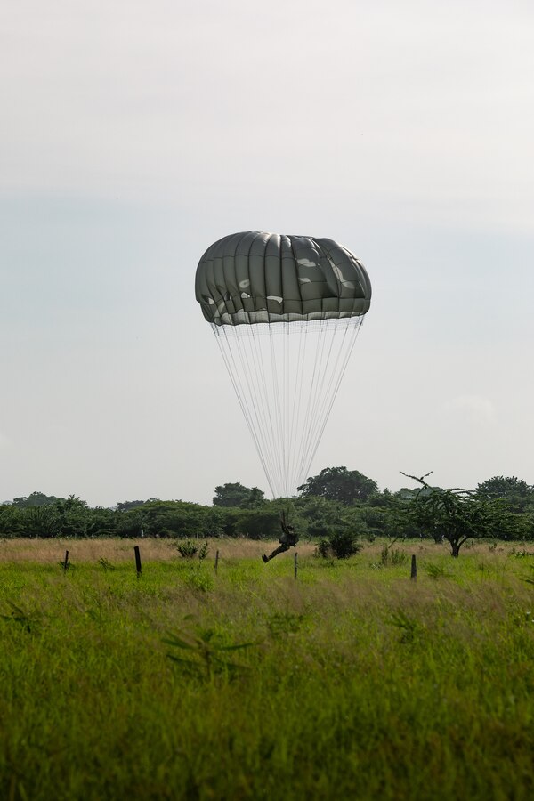 A Colombian reconnaissance Marine parachutes during low level static line training for UNITAS LXIV at Cartagena, Colombia, July 18, 2023. During UNITAS, reconnaissance and special operation force Marines from partner and allied nations conducted multilateral special operations training consisting of room clearing, visit board search and seizure, jungle patrolling, low level static line jumping, small arms, and helicopter rope suspension tactics. UNITAS, hosted by Colombia this year, is the world’s longest-running annual multinational maritime exercise that focuses on enhancing interoperability among multiple nations and joint forces during littoral and amphibious operations in order to build on existing regional partnerships and create new enduring relationships that promote peace, stability, and prosperity in the U.S. Southern Command’s area of responsibility. (U.S. Marine Corps photo by Sgt. Colton K. Garrett)
