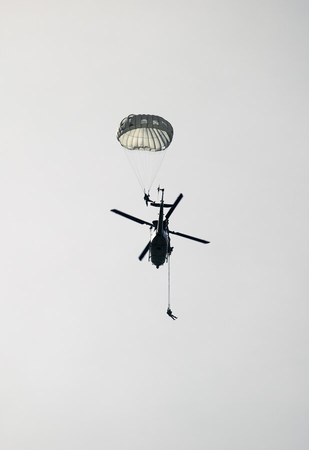 Reconnaissance Marines from partner and allied nations parachute from a U.S. Marine Corps UH-1Y Venom during low level static line training for UNITAS LXIV at Cartagena, Colombia, July 18, 2023. During UNITAS, reconnaissance and special operation force Marines from partner and allied nations conducted multilateral special operations training consisting of room clearing, visit board search and seizure, jungle patrolling, low level static line jumping, small arms, and helicopter rope suspension tactics. UNITAS, hosted by Colombia this year, is the world’s longest-running annual multinational maritime exercise that focuses on enhancing interoperability among multiple nations and joint forces during littoral and amphibious operations in order to build on existing regional partnerships and create new enduring relationships that promote peace, stability, and prosperity in the U.S. Southern Command’s area of responsibility. (U.S. Marine Corps photo by Sgt. Colton K. Garrett)