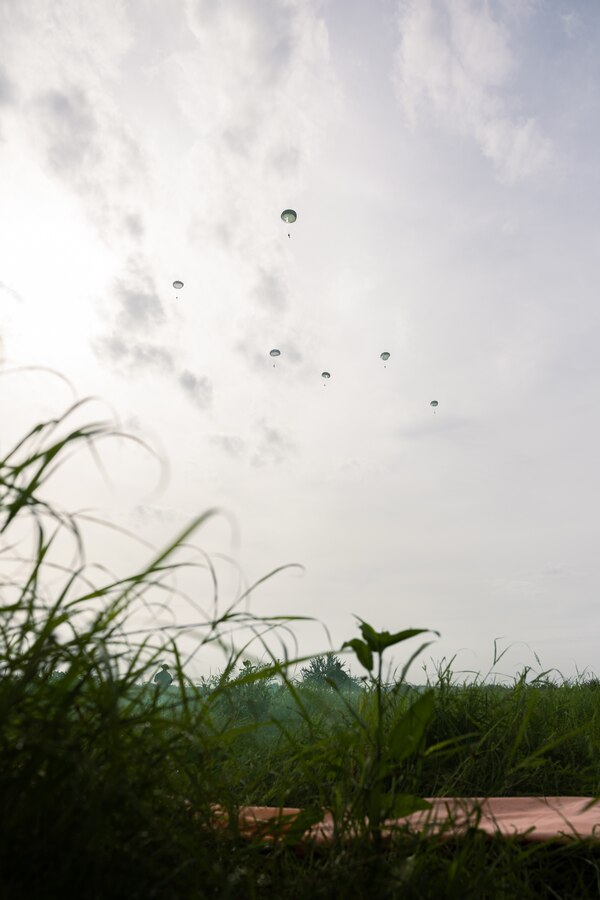 Reconnaissance Marines from partner and allied nations parachute during low level static line training for UNITAS LXIV at Cartagena, Colombia, July 18, 2023. During UNITAS, reconnaissance and special operation force Marines from partner and allied nations conducted multilateral special operations training consisting of room clearing, visit board search and seizure, jungle patrolling, low level static line jumping, small arms, and helicopter rope suspension tactics. UNITAS, hosted by Colombia this year, is the world’s longest-running annual multinational maritime exercise that focuses on enhancing interoperability among multiple nations and joint forces during littoral and amphibious operations in order to build on existing regional partnerships and create new enduring relationships that promote peace, stability, and prosperity in the U.S. Southern Command’s area of responsibility. (U.S. Marine Corps photo by Sgt. Colton K. Garrett)