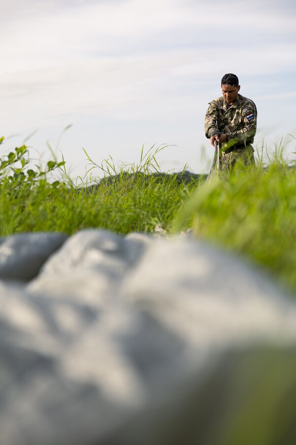 A Paraguayan reconnaissance Marine recovers his parachute after conducting a low level static line jump during UNITAS LXIV at Cartagena, Colombia, July 18, 2023. During UNITAS, reconnaissance and special operation force Marines from partner and allied nations conducted multilateral special operations training consisting of room clearing, visit board search and seizure, jungle patrolling, low level static line jumping, small arms, and helicopter rope suspension tactics. UNITAS, hosted by Colombia this year, is the world’s longest-running annual multinational maritime exercise that focuses on enhancing interoperability among multiple nations and joint forces during littoral and amphibious operations in order to build on existing regional partnerships and create new enduring relationships that promote peace, stability, and prosperity in the U.S. Southern Command’s area of responsibility. (U.S. Marine Corps photo by Sgt. Colton K. Garrett)