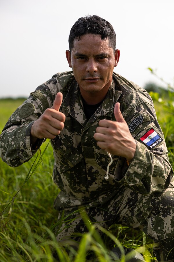 A Paraguayan reconnaissance Marine poses for a photo after conducting a low level static line jump during UNITAS LXIV at Cartagena, Colombia, July 18, 2023. During UNITAS, reconnaissance and special operation force Marines from partner and allied nations conducted multilateral special operations training consisting of room clearing, visit board search and seizure, jungle patrolling, low level static line jumping, small arms, and helicopter rope suspension tactics. UNITAS, hosted by Colombia this year, is the world’s longest-running annual multinational maritime exercise that focuses on enhancing interoperability among multiple nations and joint forces during littoral and amphibious operations in order to build on existing regional partnerships and create new enduring relationships that promote peace, stability, and prosperity in the U.S. Southern Command’s area of responsibility. (U.S. Marine Corps photo by Sgt. Colton K. Garrett)