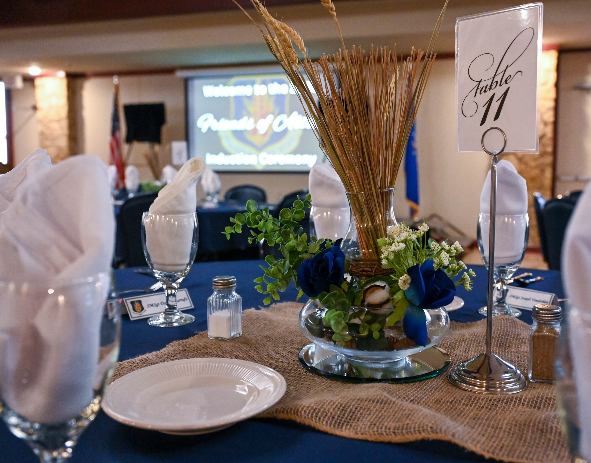 Decor that represents the local community is displayed on a dining table during the Friends of Altus ceremony at Altus Air Force Base, Oklahoma, July 11, 2023. The event was held to honor local civic leaders for their stewardship and contributions to the Altus community. (U.S. Air Force photo by Airman 1st Class Heidi Bucins)