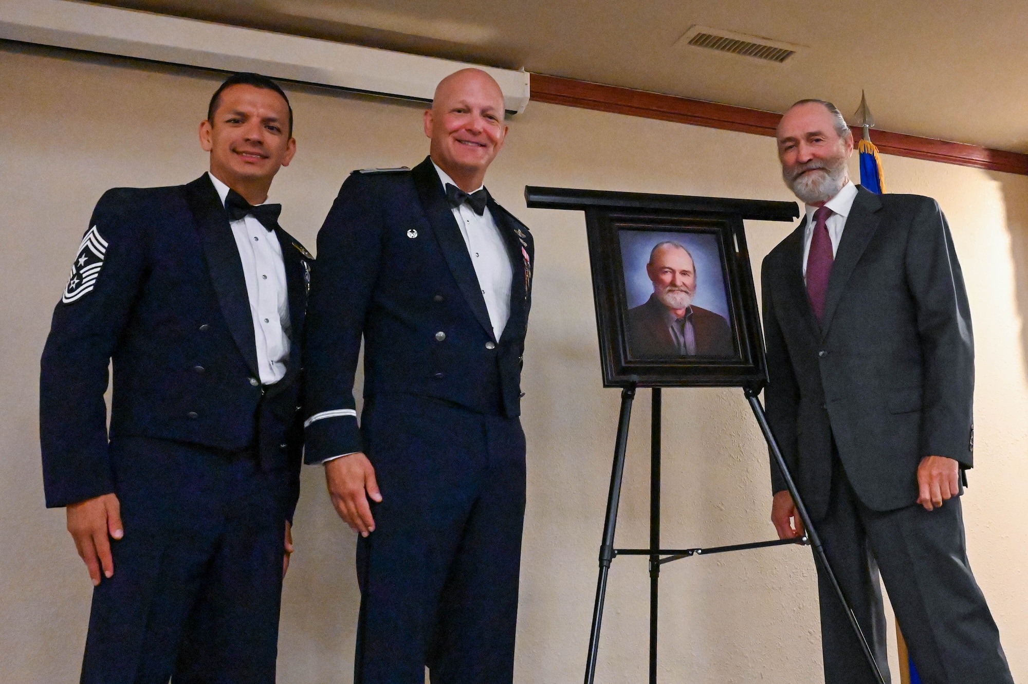 U.S. Air Force Col. Blaine Baker, 97th Air Mobility Wing commander (center) and Chief Master Sgt. Cesar Flores, 97th Air Mobility Wing command chief (left), pose for a photo with Tom Buchanan, general manager of the Altus-Lugert Irrigation District (right), during the Friends of Altus induction at Altus Air Force Base, Oklahoma July 11, 2023. Buchanan was honored as an outstanding civic leader for his contributions to the Altus community. (U.S. Air Force photo by Airman 1st Class Heidi Bucins)