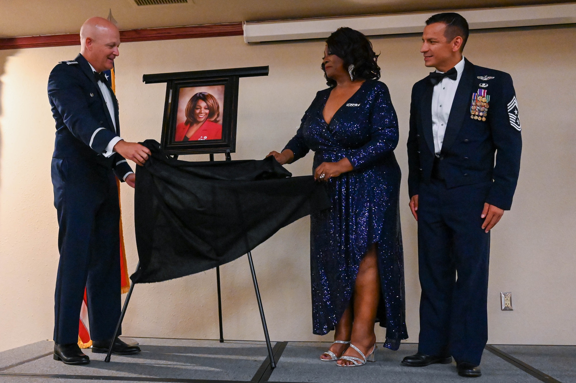 U.S. Air Force Col. Blaine Baker, 97th Air Mobility Wing commander (left) and Roberta Brady-Lee, vice mayor of Altus, unveil her portrait during the Friends of Altus induction at Altus Air Force Base, Oklahoma July 11, 2023. Brady-Lee has supported Altus Air Force Base Airmen as a keynote speaker focusing on diversity and inclusion. (U.S. Air Force photo by Airman 1st Class Heidi Bucins)
