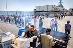 USS Abraham Lincoln (CVN 72) project team members celebrate with a barbecue June 27, 2023, in San Diego, after reaching the 50-percent mark in the carrier's six-month planned incremental availability at Puget Sound Naval Shipyard & Intermediate Maintenance Facility Detachment San Diego. The availability began April 1. Reaching the 50-percent milestone keeps the project team on track for an on-time completion.