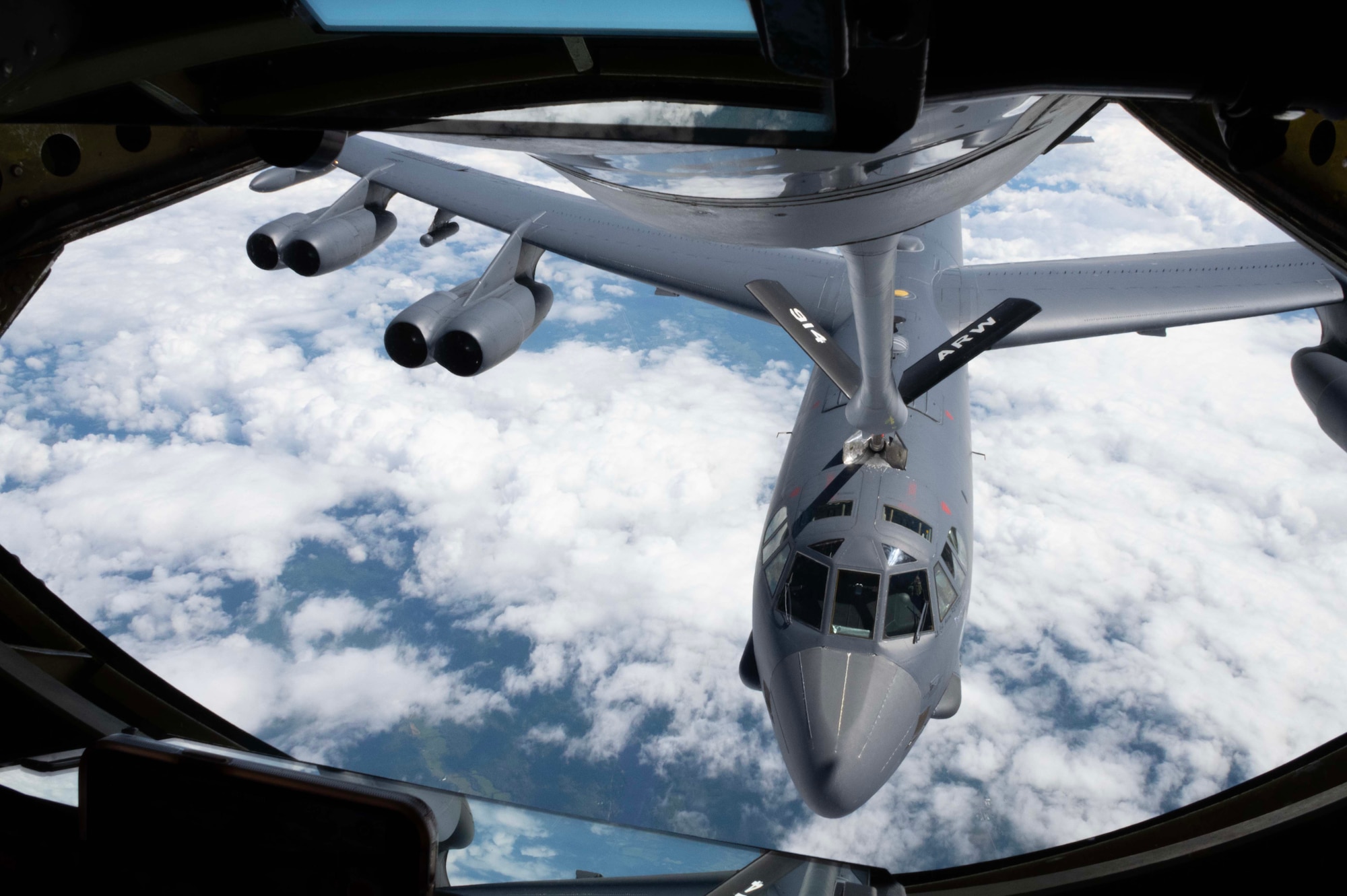 A KC-135 Stratotanker fuels a B-52 in the sky during an Agile Combat Employment exercise, June 26, 2023.