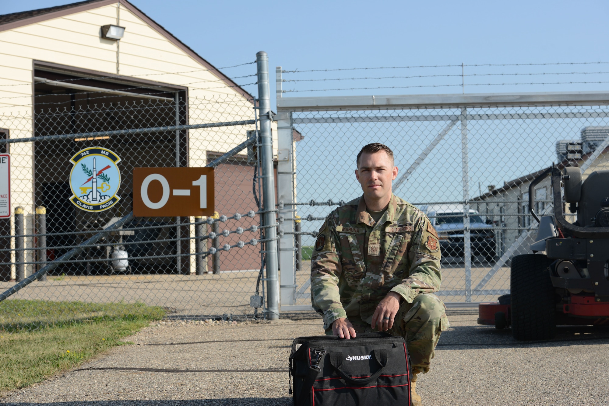 U.S. Air Force Staff Sgt. Edward Maruna, 742nd Missile Squadron facility manager, grabs his tool bag and lawn mower to start maintenance at a missile access facility at Minot Air Force Base, North Dakota, July 7, 2023. Maruna makes sure the MAF is properly functioning and accessible for the 91st Security Forces Squadron to safeguard the site and all of its components. (U.S. Air Force photo by Airman 1st Class Trust Tate)