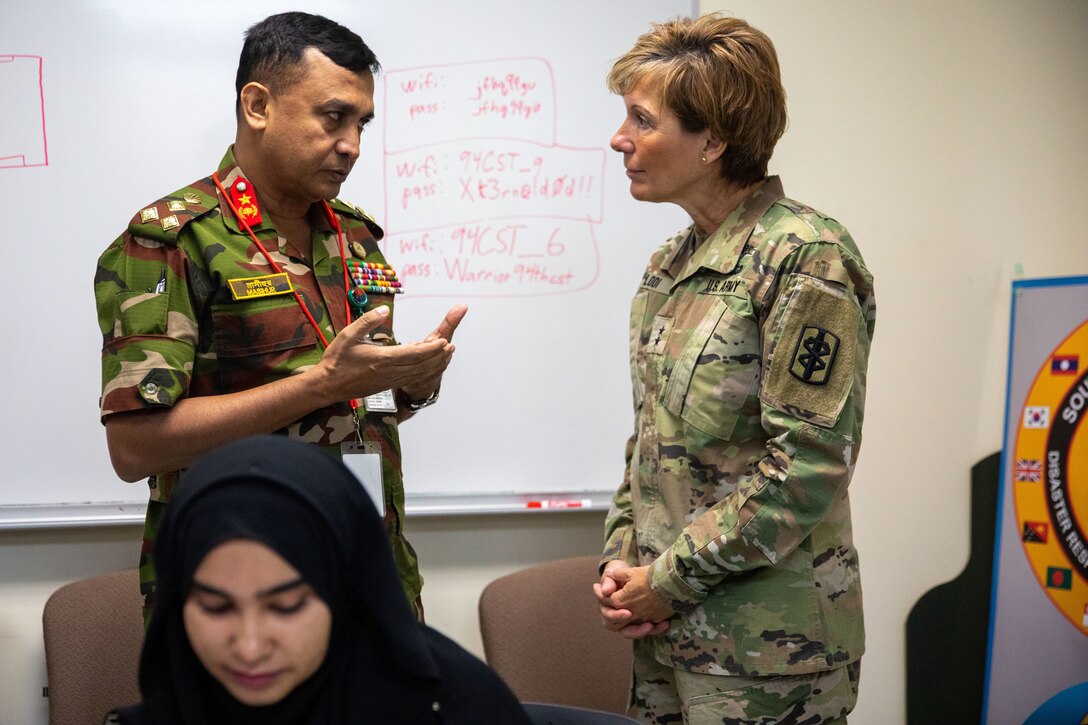 Brig. Gen. Hussain Muhammad Masihur Rahman, directorate general of ops and planning, armed forces division, Bangladesh Army and U.S. Army Brig. Gen. Paula C. Lodi, commanding general 18th medical command United States Army Indo-Pacific Command (USARPAC) exchange ideas during a Women, Peace & Security (WPS) workshop, at the inaugural South Asia Regional Disaster Response Exercise (DREE), Guam Army National Readiness Training Center, Guam, 13 July 20203. DREE aims to enhance regional cooperation and camaraderie, strengthen disaster response capabilities, and improve overall strategies, mechanisms, and coordination efforts. (U.S. Army photo by Spc. Elizabeth MacPherson)