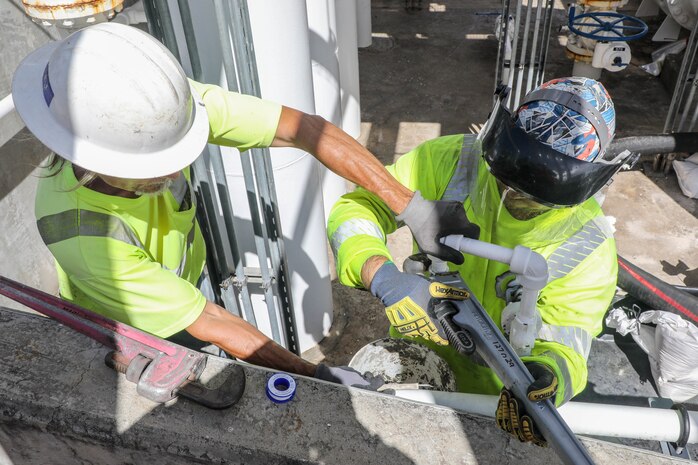 Civilians assigned to Joint Task Force-Red Hill (JTF-RH) remove air from a fuel line during the draining of surge tanks at the Red Hill Bulk Fuel Storage Facility (RHBFSF), Honolulu, Hawaii, July 18, 2023. JTF-RH is in phase three of its five-phase defueling plan. Personnel are focused on completing quality control tasks, training, response preparation, the National Environmental Policy Act Environmental Assessment, regulatory approvals and operational planning for all future major milestones. This extensive preparatory work will help ensure the safe and expeditious defueling of the RHBFSF. (DoD photo by U.S. Army Sgt. Kyler L. Chatman)