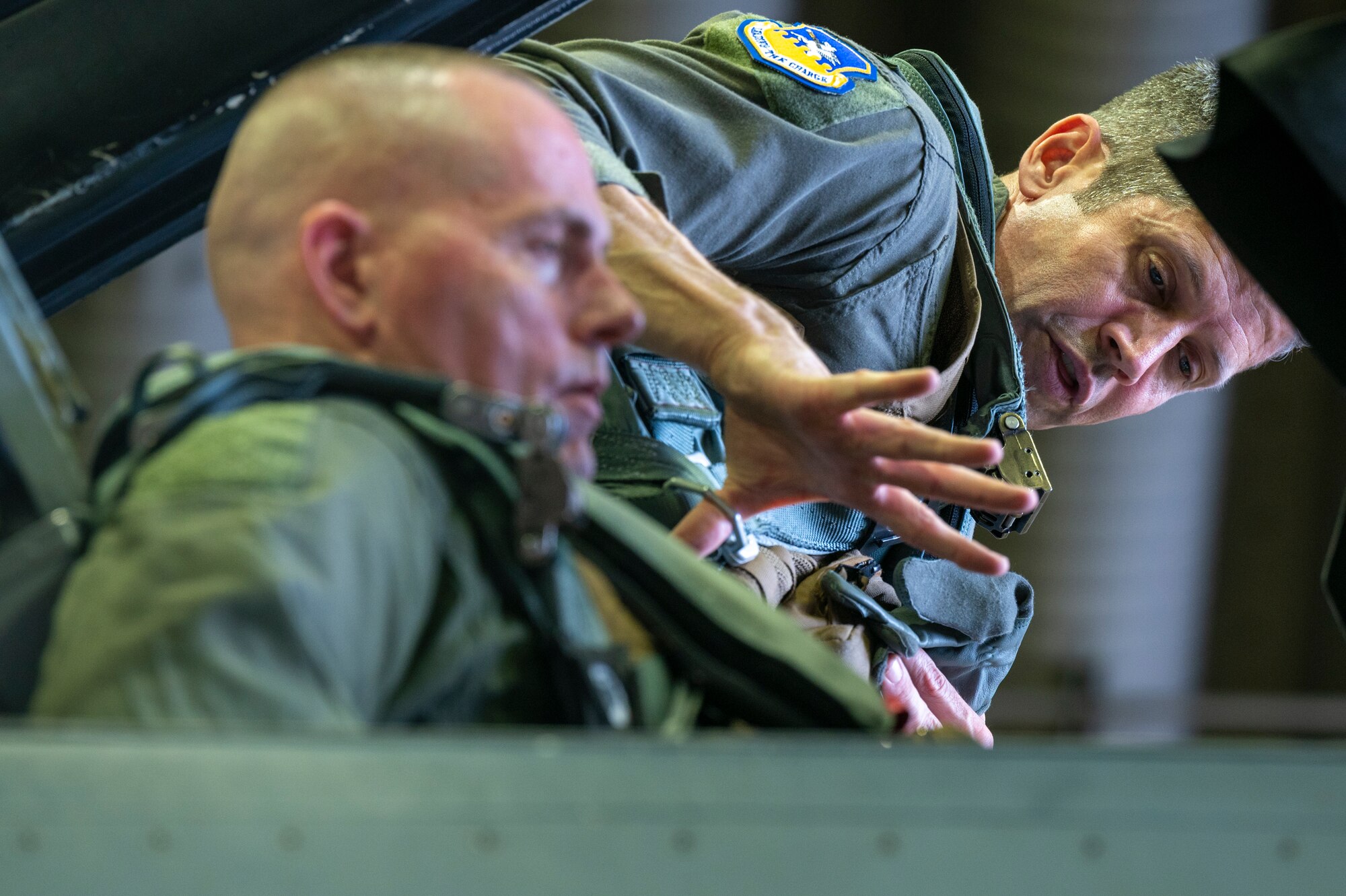 U.S. Air Force Col. William McKibban, right, 51st Fighter Wing commander, helps U.S. Army Command Sgt. Maj. Jack Love, U.S. Forces Korea Senior Enlisted Advisor, strap into an F-16D Fighting Falcon at Osan Air Base, Republic of Korea, July 18, 2023. Love visited the 36 FS for a familiarization flight in a F-16D Fighting Falcon. (U.S. Air Force photo by Senior Airman Aaron Edwards)