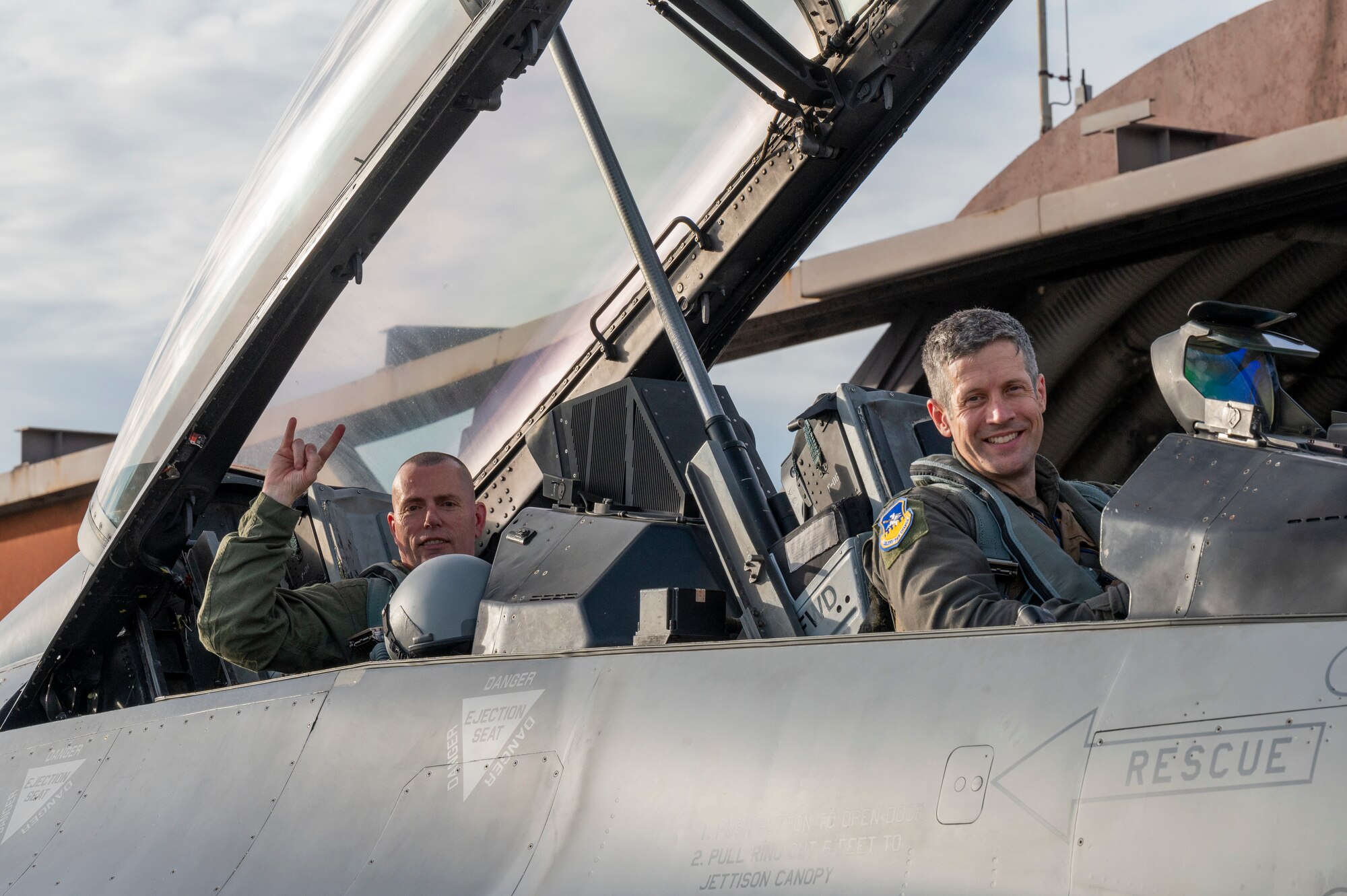 U.S. Air Force Col. William McKibban, right, 51st Fighter Wing commander, and U.S. Army Command Sgt. Maj. Jack Love, U.S. Forces Korea Senior Enlisted Advisor, pose for a photo in an F-16D Fighting Falcon at Osan Air Base, Republic of Korea, July 18, 2023. Love visited the 51 FW and 36th Fighter Squadron for a familiarization flight, allowing him to see what goes into scheduling, generating and launching an aircraft. (U.S. Air Force photo by Senior Airman Aaron Edwards)