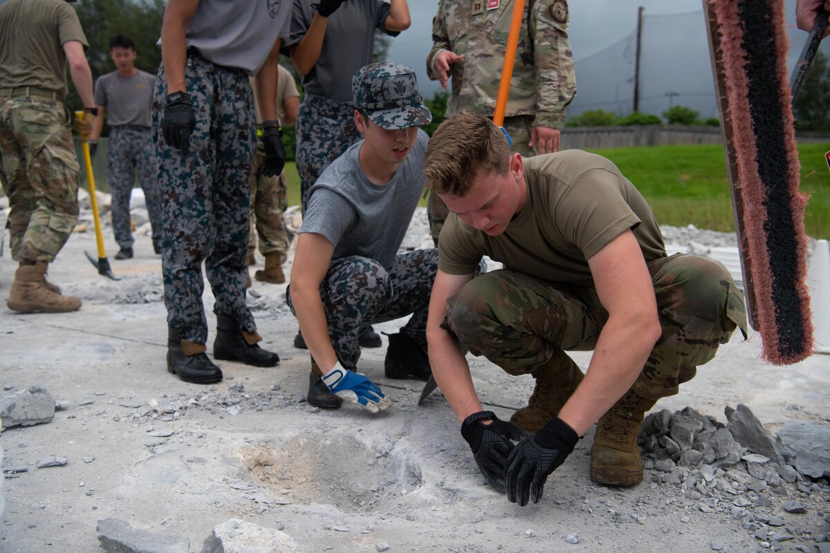 Men fill a hole.