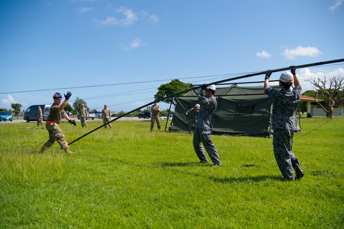 Service members put up a radio tower.
