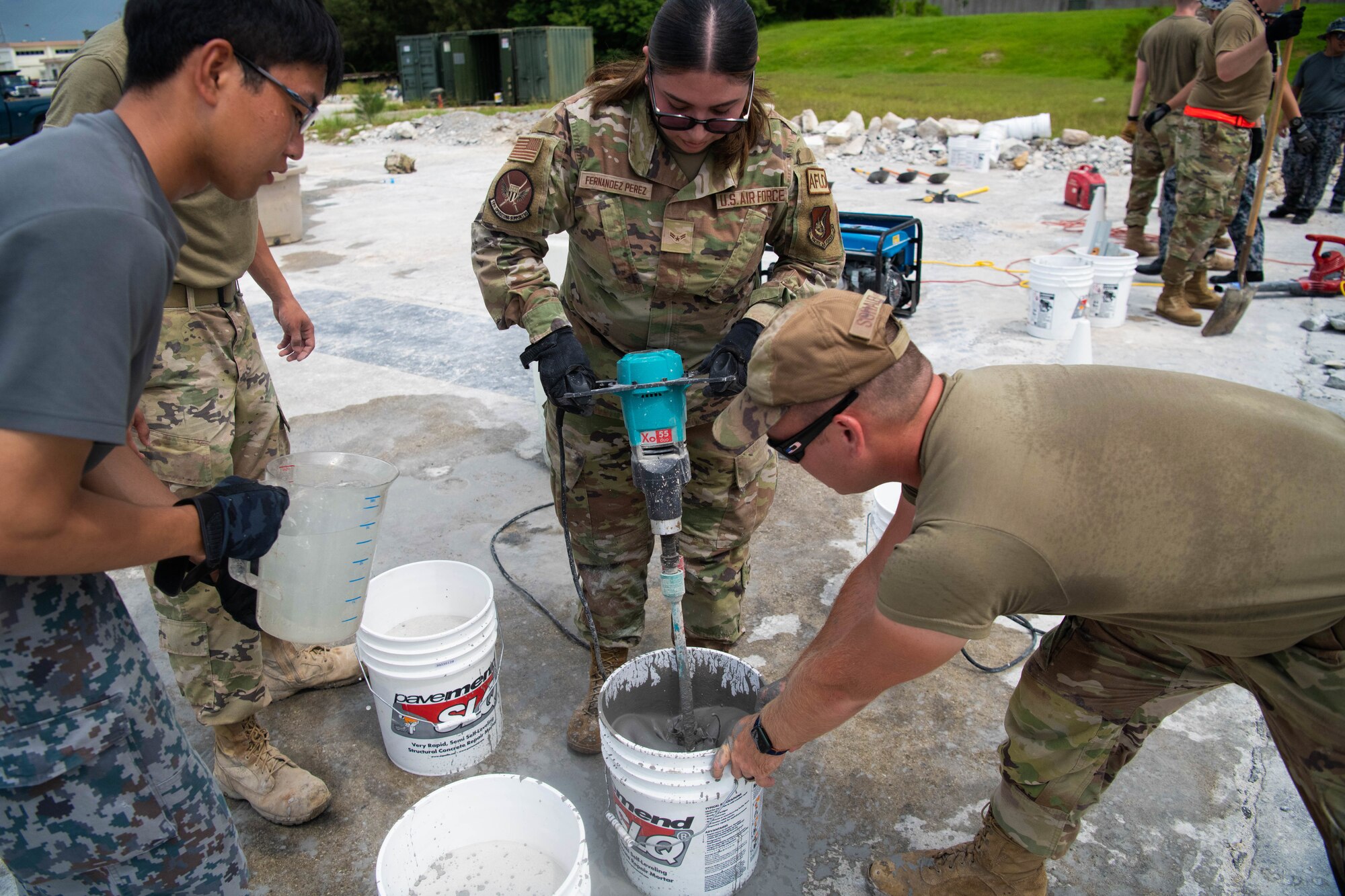 Service members fill buckets.