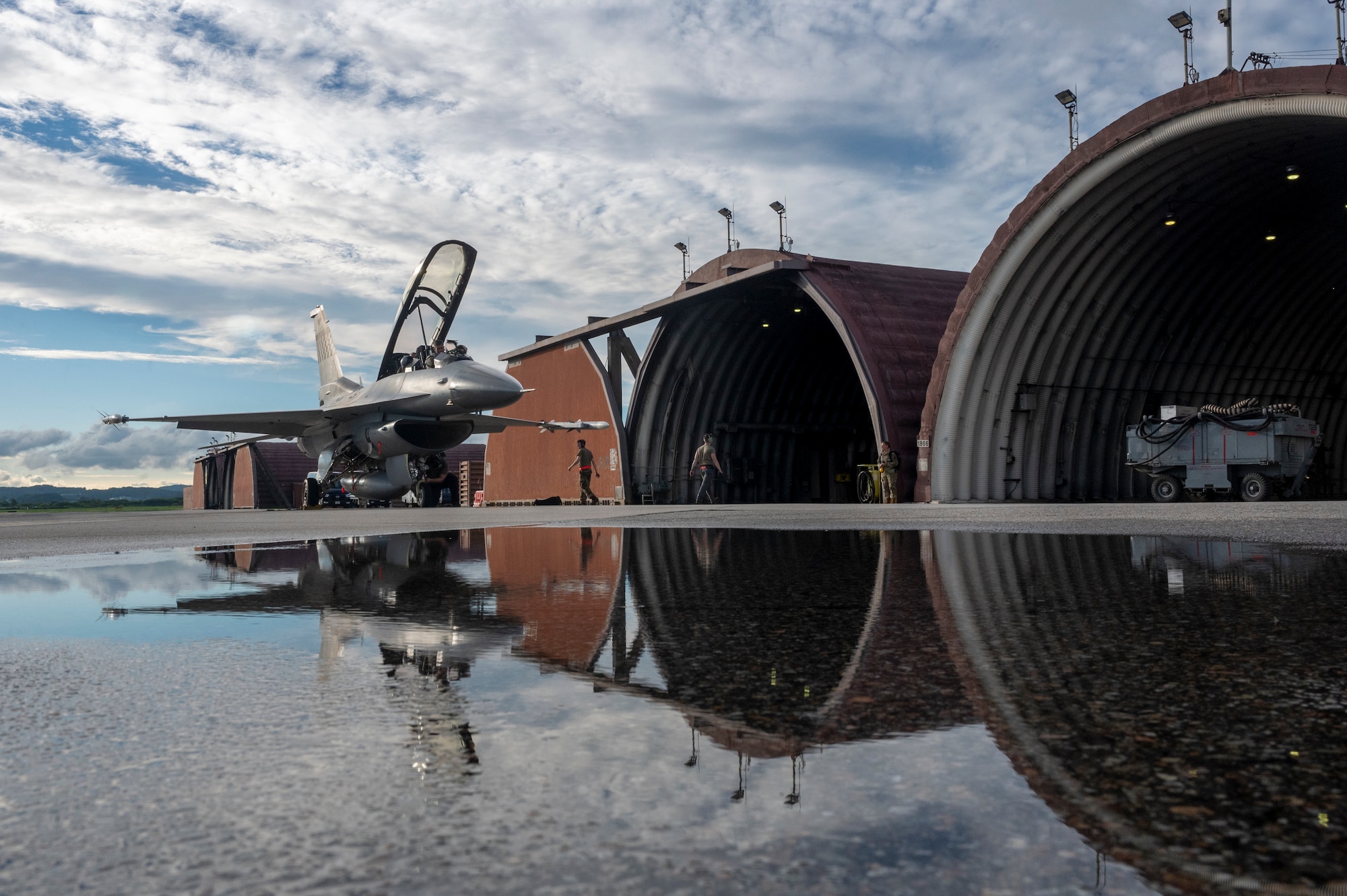 U.S. Air Force 36th Fighter Generations Squadron maintainers prepare to store an F-16D Fighting Falcon in a hangar after completing a familiarization flight with Col. William McKibban, 51st Fighter Wing commander, and U.S. Army Command Sgt. Maj. Jack Love, U.S. Forces Korea Senior Enlisted Advisor, at Osan Air Base, Republic of Korea, July 18, 2023. The D-model is a two-seat variant of the F-16 fighter jet which allows for familiarization flights to showcase the 51 FW mission. (U.S. Air Force photo by Senior Airman Aaron Edwards)