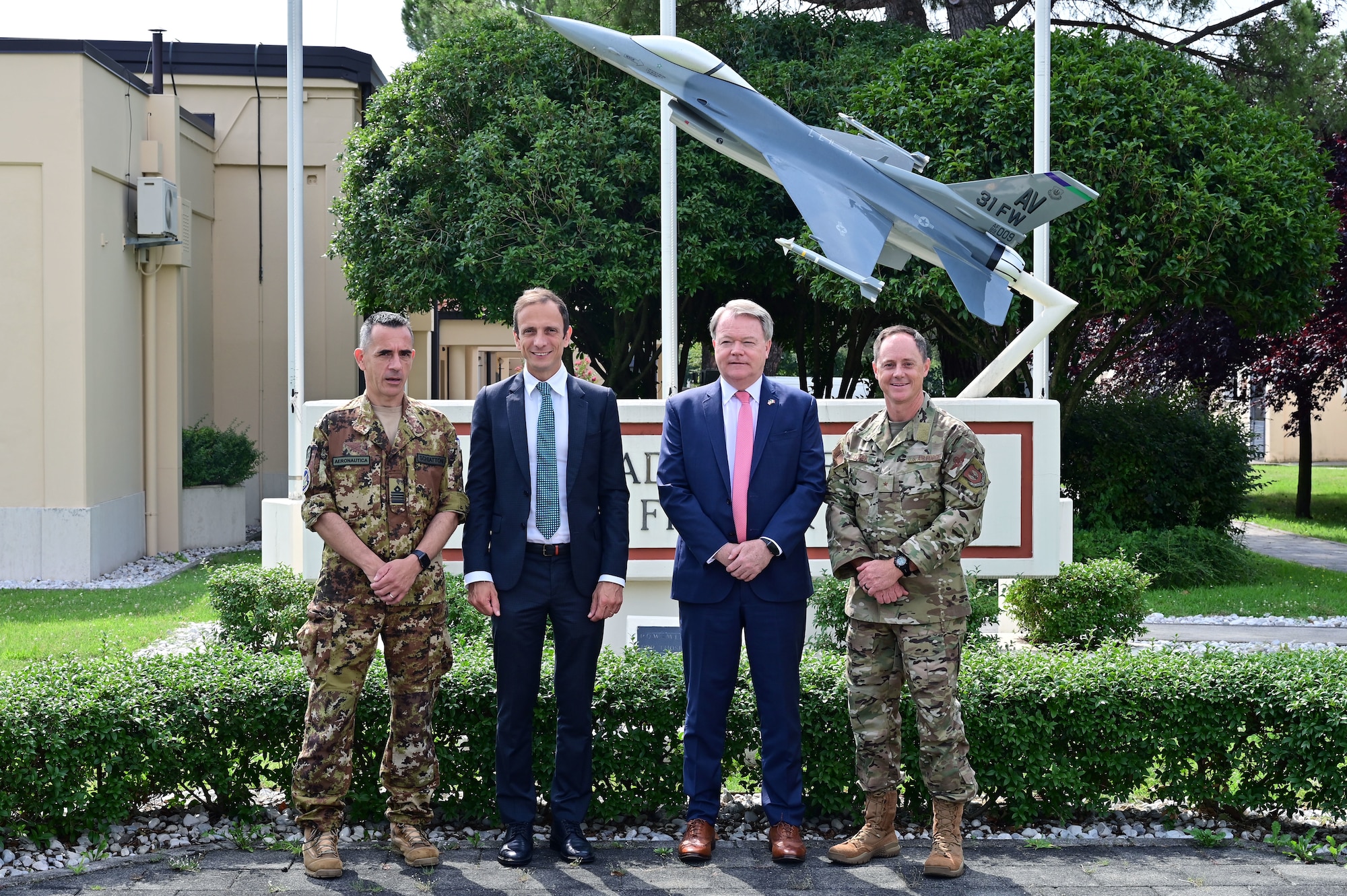 a group of people standing in front of the wing hq building