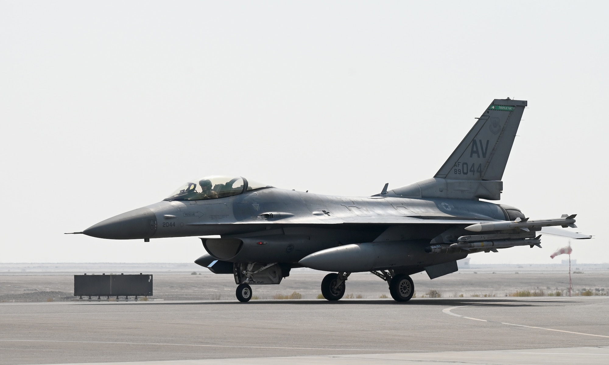 A photo of a jet taxiing on a flightline.