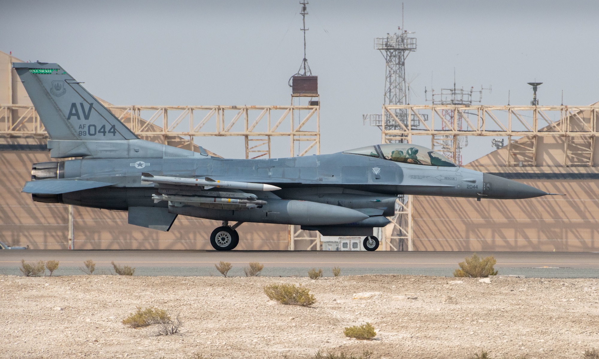 A photo of a jet taxiing down a flightline.