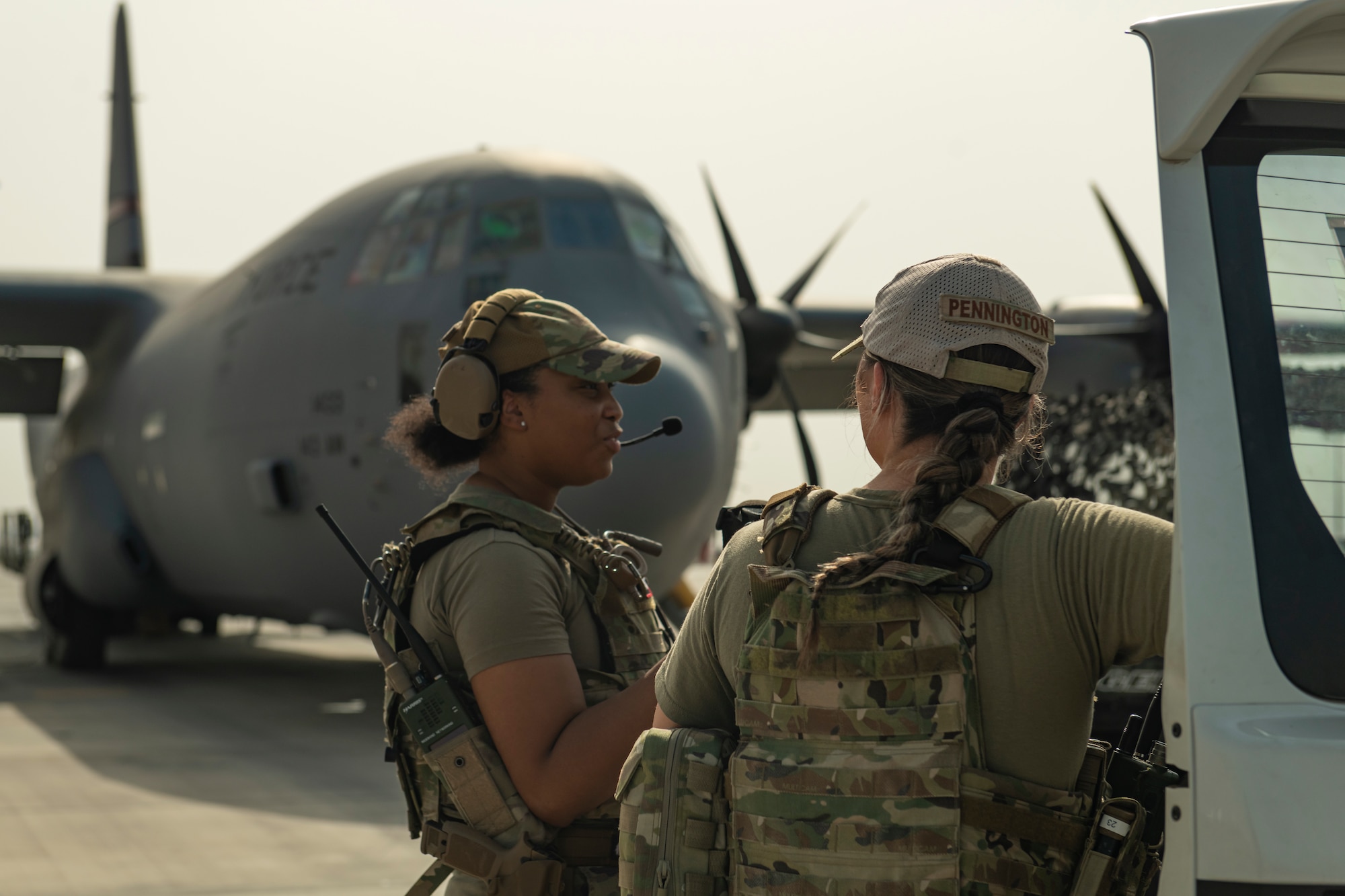 Photo of two women in front of an airplane