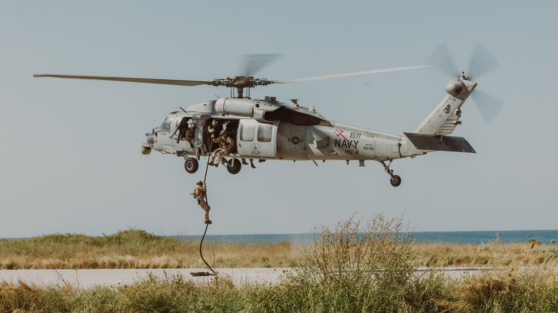 U.S. Marines with Force Company, 2d Reconnaissance Battalion, 2d Marine Division, under tactical control of Task Force 61/2, fast rope out of a MH-60S helicopter in Souda Bay, Greece on July 19, 2023. Task Force 61/2.5 provides naval and joint force commanders with dedicated multi-domain reconnaissance and counter reconnaissance (RXR) capabilities. (U.S. Marine Corps photo by Lance Cpl. Emma Gray)