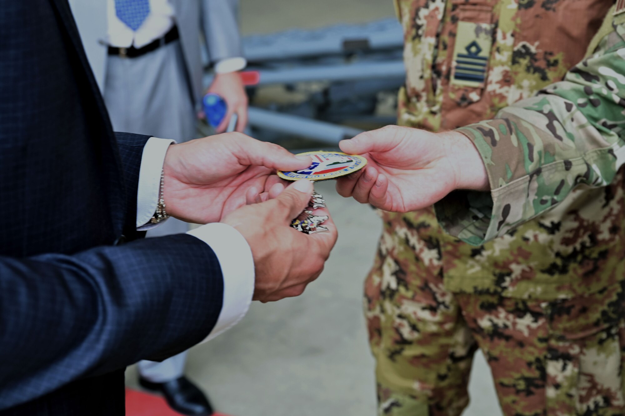 patch and coin being handed to person