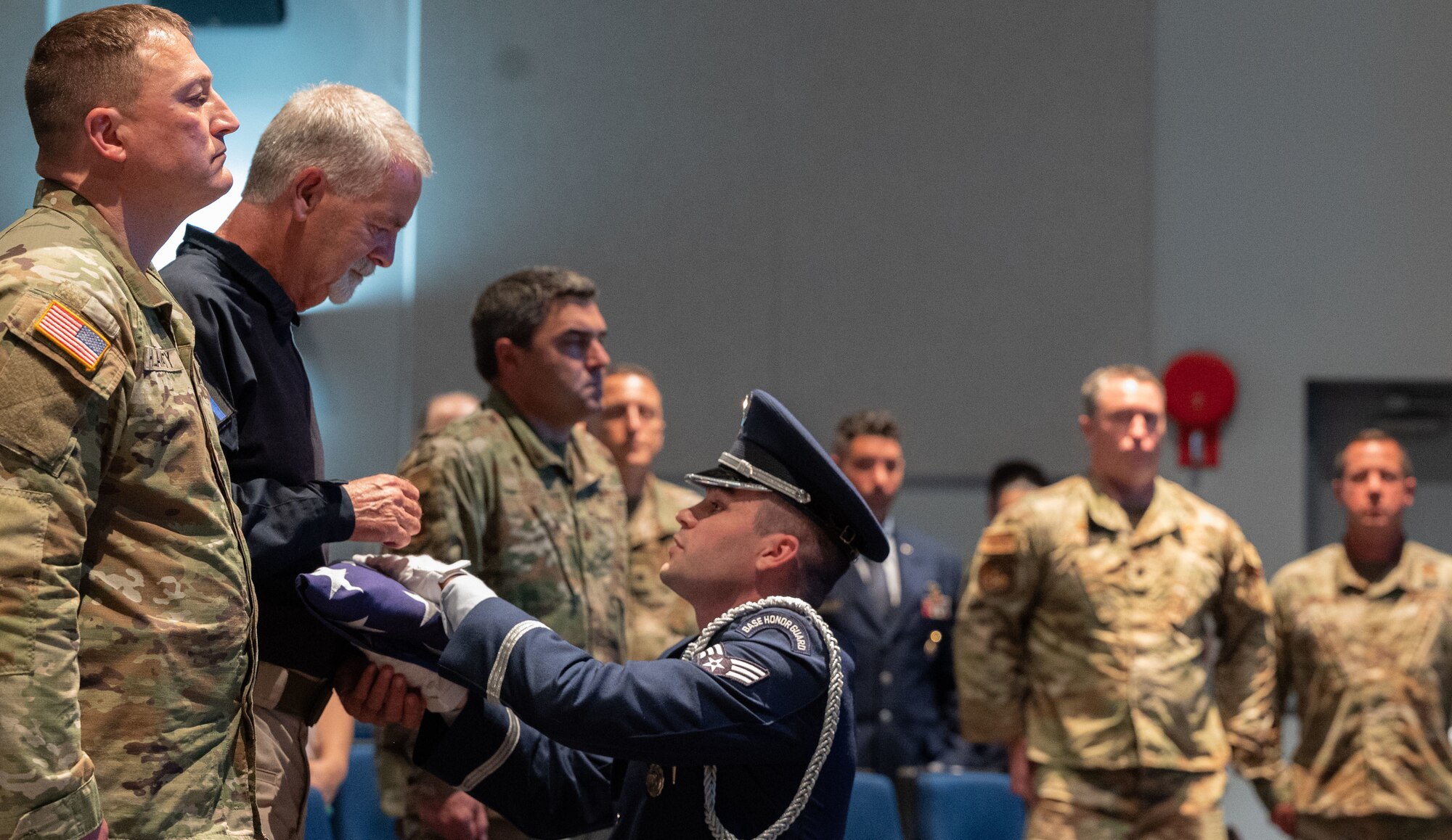 U.S. Air Force retired Staff Sgt. Mark Smoot, Military Working Dog OX14 Jake’s handler, receives a flag during a memorial ceremony at Dover Air Force Base, Delaware, July 10, 2023. The 436th SFS held the memorial ceremony in hopes of providing closure to retired U.S. Air Force Staff Sgt. Mark Smoot, MWD Jake’s handler, during their deployment to Vietnam in 1971. (U.S. Air Force photo by Airman 1st Class Dieondiere Jefferies)