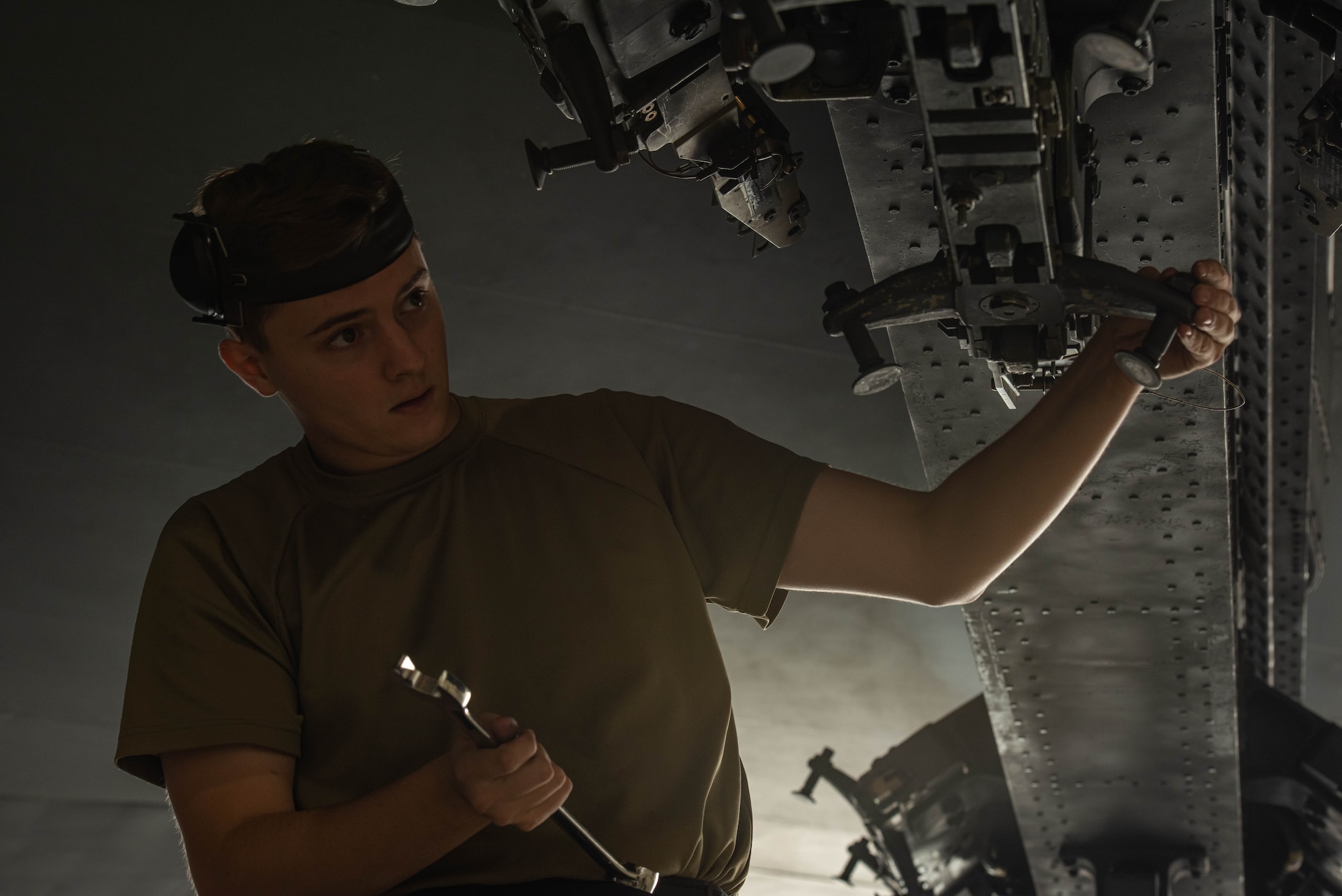 Senior Airman Cody Brittain, 5th Aircraft Maintenance Squadron load crew member, prepares a B-52H Stratofortress for weapons loading at Minot Air Force Base, July 14, 2023. Brittain was competing in a quarterly weapons load competition with his team. (U.S. Air Force photo by Airman 1st Class Kyle Wilson)