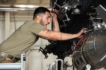 U.S. Air Force Staff Sergeant Christian Ybarra, 5th Aircraft Maintenance Squadron load crew member, yells directions for his team at Minot Air Force Base, North Dakota, July 14, 2023. Ybarra instructed his team while loading an inert precision guided munition onto a B-52H Stratofortress for a quarterly weapons load competition. (U.S. Air Force photo by Airman 1st Class Kyle Wilson)