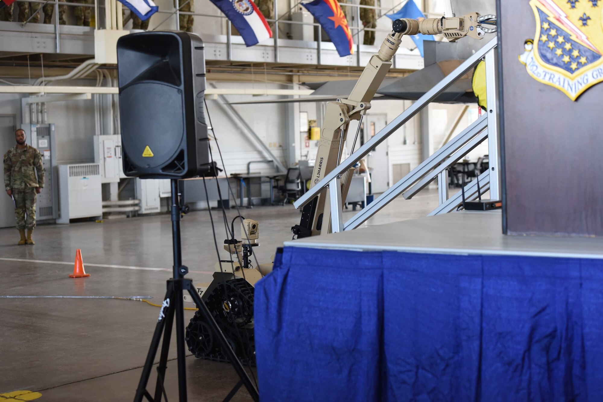 A robot for explosive ordnance disposal brings Colonel Daniel Lemon's Legion of Merit award to the stage during his change of command on July 19th, 2023 at Sheppard Air Force Base, Texas. The 782d TRG is known to be the most diverse training group in the Air Force, including courses in civil engineering, petroleum oil lubricants, hydraulics, electrical and environmental systems, avionics, and more.