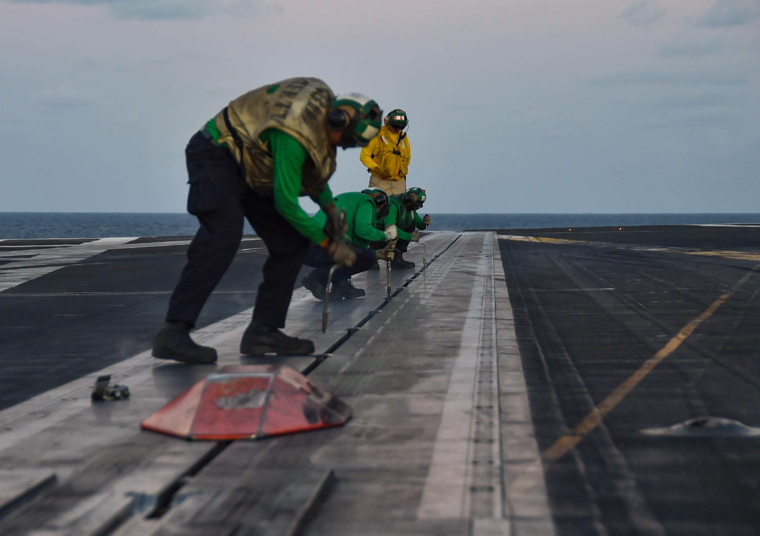 Sailors perform catapult maintenance on the flight deck aboard the U.S. Navy’s only forward-deployed aircraft carrier, USS Ronald Reagan (CVN 76), in the Indian Ocean, July 19, 2023.