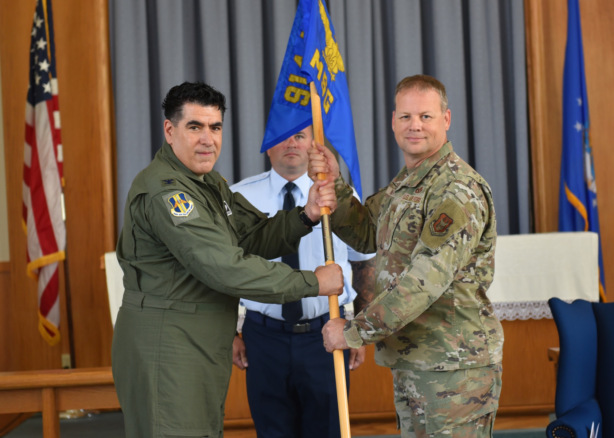 Col. Randall Roberts (right), receives the 914th Mission Support Group guidon and thereby command of the group from Col. Joseph Contino, 914th Air Refueling Wing commander, as Chief Master Sgt. Christopher McArdle, 914 MSG superintendent, stands as guidon bearer during an assumption of command ceremony July 19, 2023 at Niagara Falls Air Reserve Station, New York.