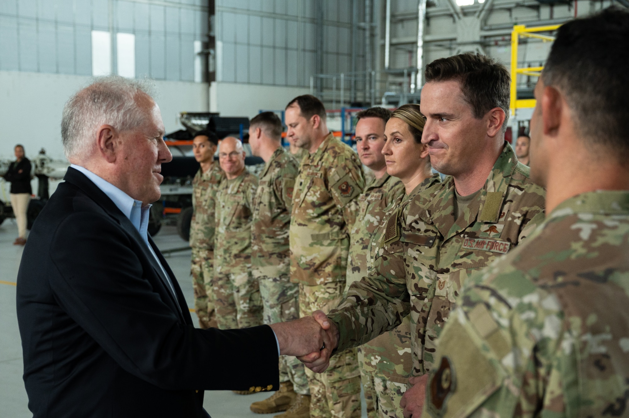 Secretary of the Air Force Frank Kendall shakes hands with 352nd Special Operations Wing personnel at Royal Air Force Mildenhall, England, July 13, 2023.