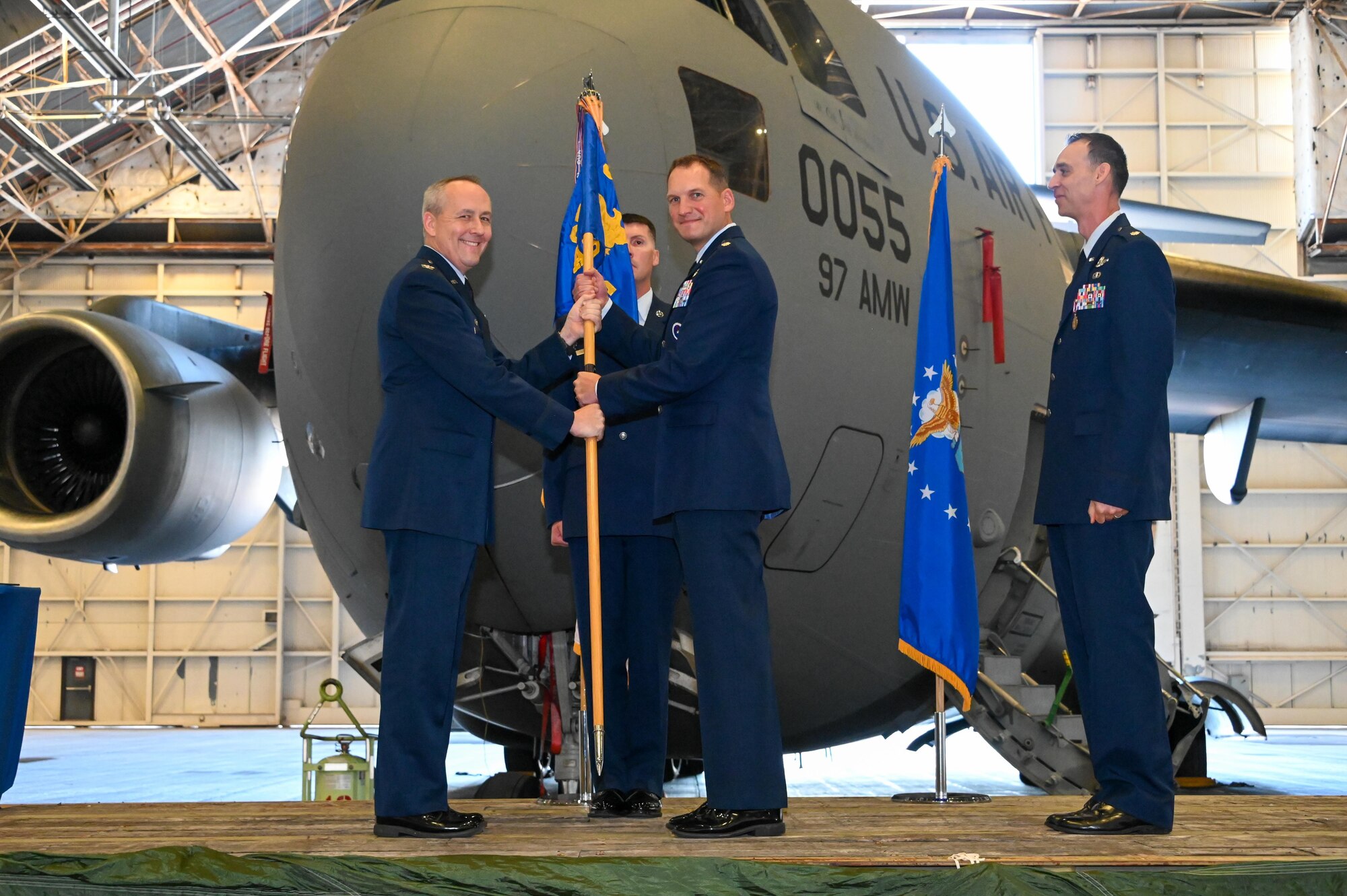 U.S. Air Force Col. Scott Linck, 97th Operations Group commander, passes the 58th Airlift Squadron (AS) guidon to Lt. Col. Peter Bulinski, 58th AS commander, during a change of command ceremony at Altus Air Force Base (AFB), Oklahoma, June 9, 2023. Under the Air Education and Training Command, the 58th AS is responsible for the formal flight training of all C-17 Globemaster III pilots and loadmasters, as well as maintaining worldwide readiness in case of contingencies requiring highly experienced aircrews. (U.S. Air Force photo by Senior Airman Kayla Christenson)