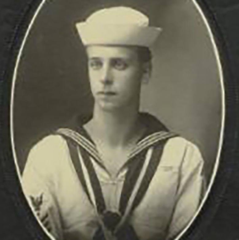 A man in a dress uniform and cap poses for a photo that’s framed in an oval.