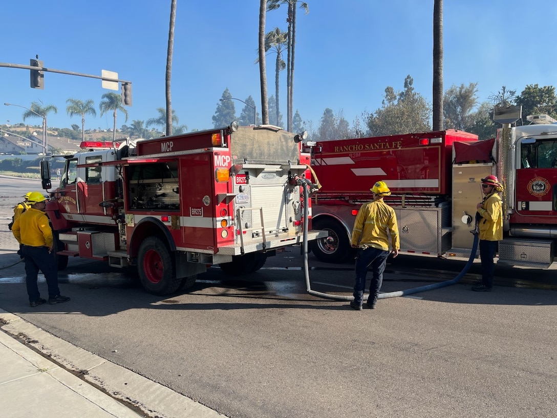Firefighters with Camp Pendleton Fire Department and Rancho Santa Fe Fire Department work to put out a fire in Oceanside California, July 9, 2023. Camp Pendleton Fire Department worked alongside the Oceanside Fire Department and other local first responders to extinguish the fire and keep neighboring communities safe.