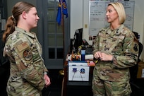 Master Sgt. Britni Burnette (right), 90th Operations Group first sergeant, talks with Airman Jenna Lawson (left), 90th Operations Support Squadron commander’s support staff, on F.E. Warren Air Force Base, Wyoming, May 5, 2023. Burnette’s efforts as 90 OG first sergeant earned her the Air Force Global Strike Command’s award for “Outstanding First Sergeant of the Year.” (U.S. Air Force photo by Joseph Coslett Jr.)