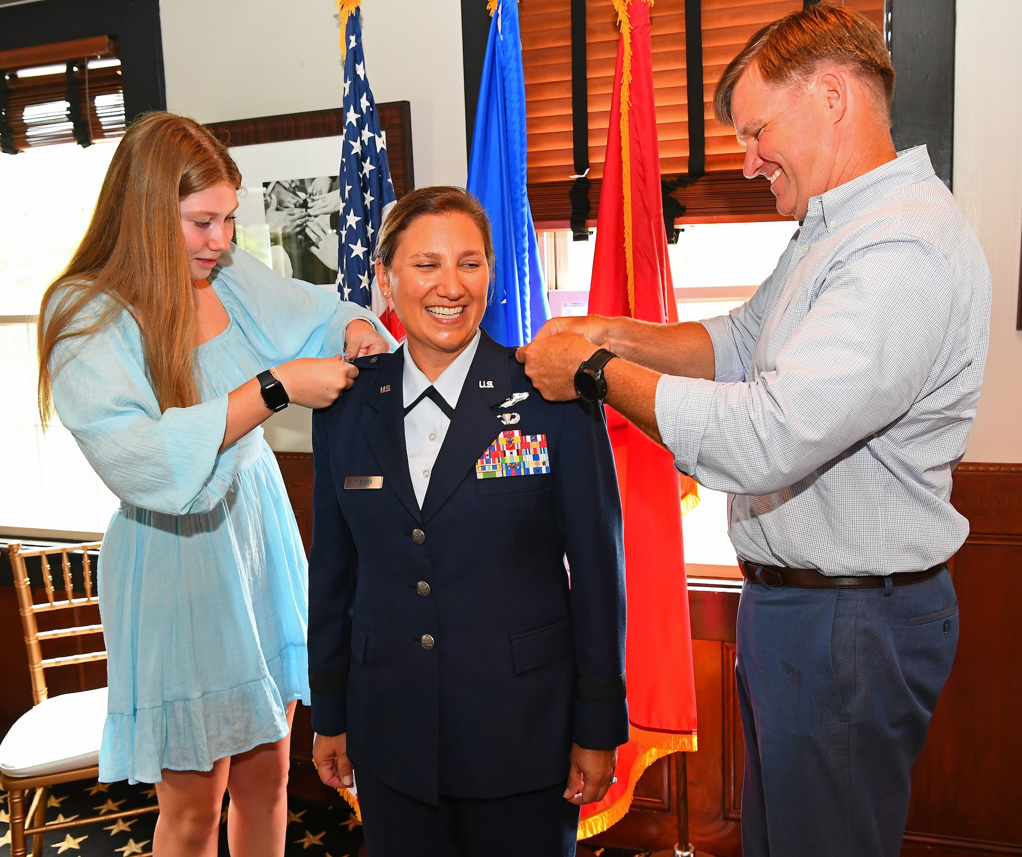 The family of U.S. Air Force Brig. Gen. Amy Kremser, Maryland National Guard Joint Staff director, place brigadier general rank on her uniform during her promotion ceremony, July 8, 2023, in Annapolis, Maryland.