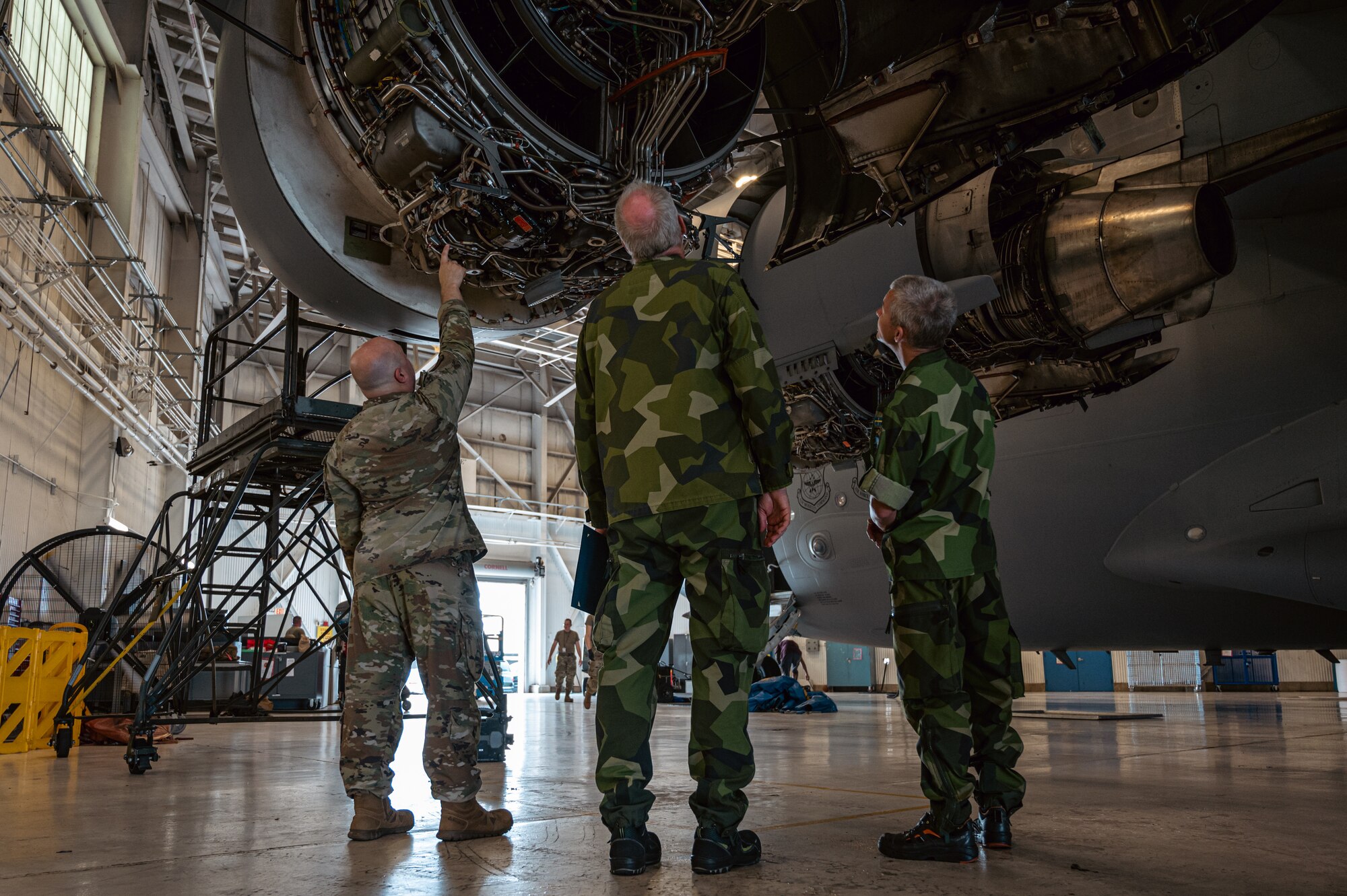 Members of the Swedish Air Force conduct hands-on training during the first C-17 Flying Crew Chief Strategic Airlift Capability Course held for international students at Joint Base McGuire-Dix-Lakehurst, N.J., July 17, 2023. The five-week course is intended to build interoperability between our allies and partners in an effort to bridge knowledge gaps in aircraft maintenance necessary for Rapid Global Mobility and meeting National Defense Strategy requirements. (U.S. Air Force photo by Senior Airman Sergio Avalos)