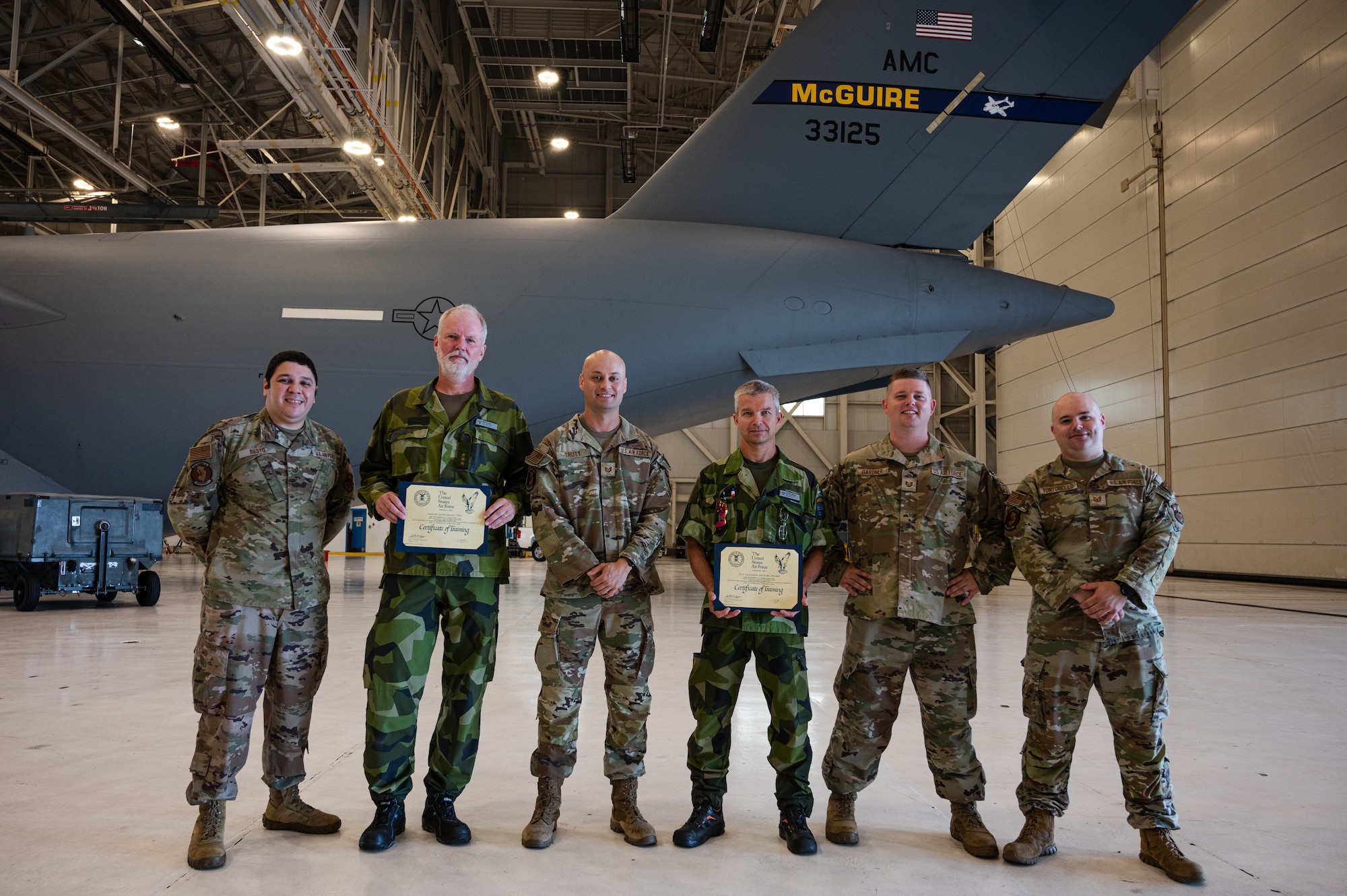 Members of the Swedish Air Force conduct hands-on training during the first C-17 Flying Crew Chief Strategic Airlift Capability Course held for international students at Joint Base McGuire-Dix-Lakehurst, N.J., July 17, 2023. The five-week course is intended to build interoperability between our allies and partners in an effort to bridge knowledge gaps in aircraft maintenance necessary for Rapid Global Mobility and meeting National Defense Strategy requirements. (U.S. Air Force photo by Senior Airman Sergio Avalos)
