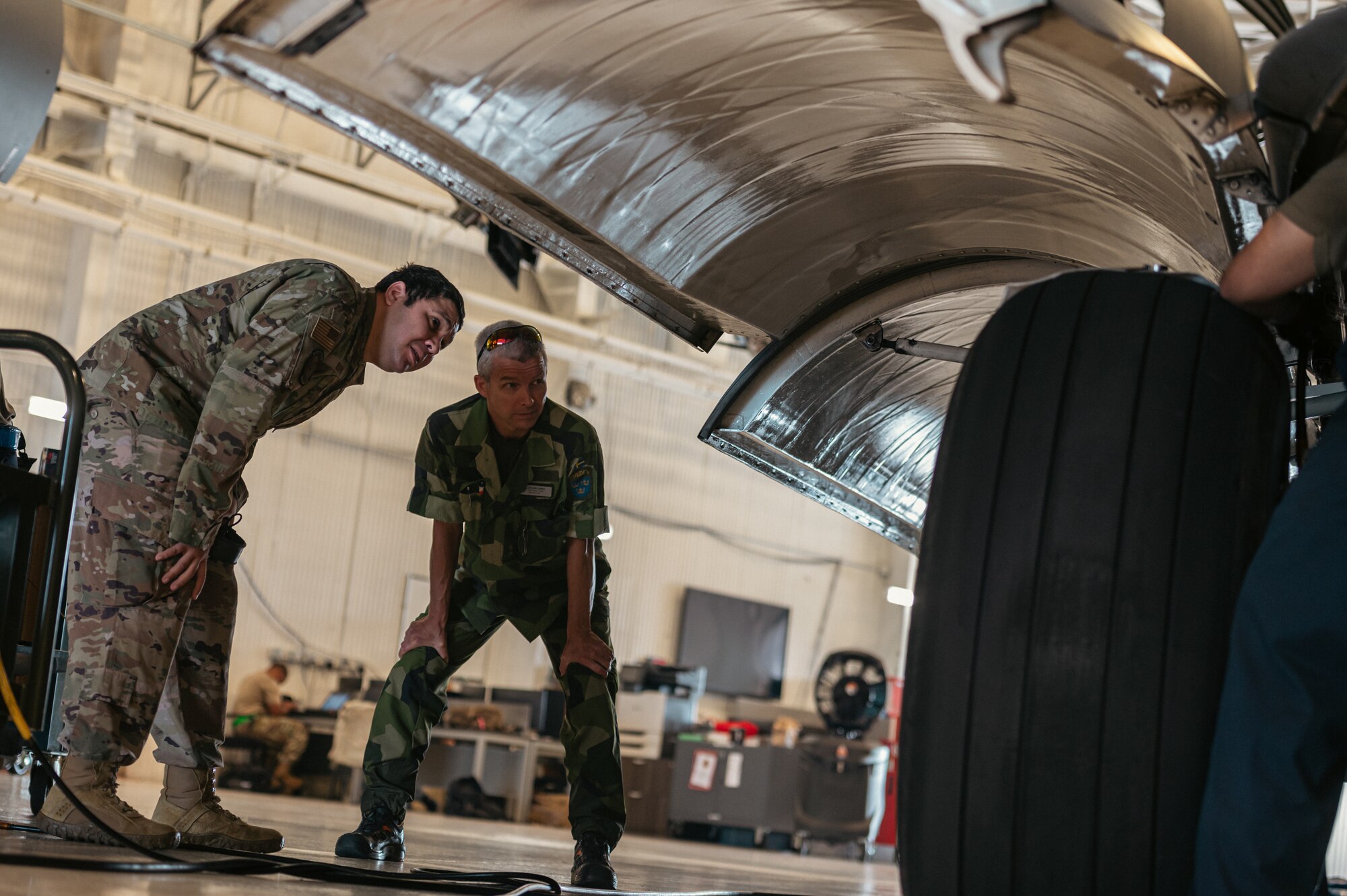 Members of the Swedish Air Force conduct hands-on training during the first C-17 Flying Crew Chief Strategic Airlift Capability Course held for international students at Joint Base McGuire-Dix-Lakehurst, N.J., July 17, 2023. The five-week course is intended to build interoperability between our allies and partners in an effort to bridge knowledge gaps in aircraft maintenance necessary for Rapid Global Mobility and meeting National Defense Strategy requirements. (U.S. Air Force photo by Senior Airman Sergio Avalos)