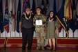 U.S. Army Spc. Rene J. Rodriguez (center), a combat medic assigned to 2nd Battalion, 35th Infantry Regiment, 3rd Infantry Brigade Combat Team, 25th Infantry Division, stands with his parents to be recognized after receiving the Soldier's Medal, July 19, 2023, Schofield Barracks, Hawaii. Rodriguez received the Soldier's Medal, the highest peacetime Army award a Soldier can receive, for protecting the life of a Hawaiian woman Oct. 20, 2022. (U.S. Army photo by Sgt. Richard Mohr)
