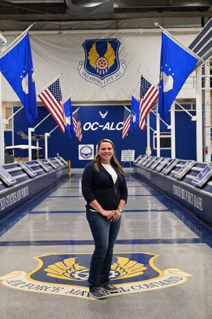 Col Aaron Heick, mobilization assistant to the Commander, Oklahoma City Air Logistics Complex presents Tonya Perkins with  the Commanders Excellence In Action award for developing an comprehensive book for the 551st CMXG commodities maintenance squadron. The book provides a high level process maps for every shop within the 551st.