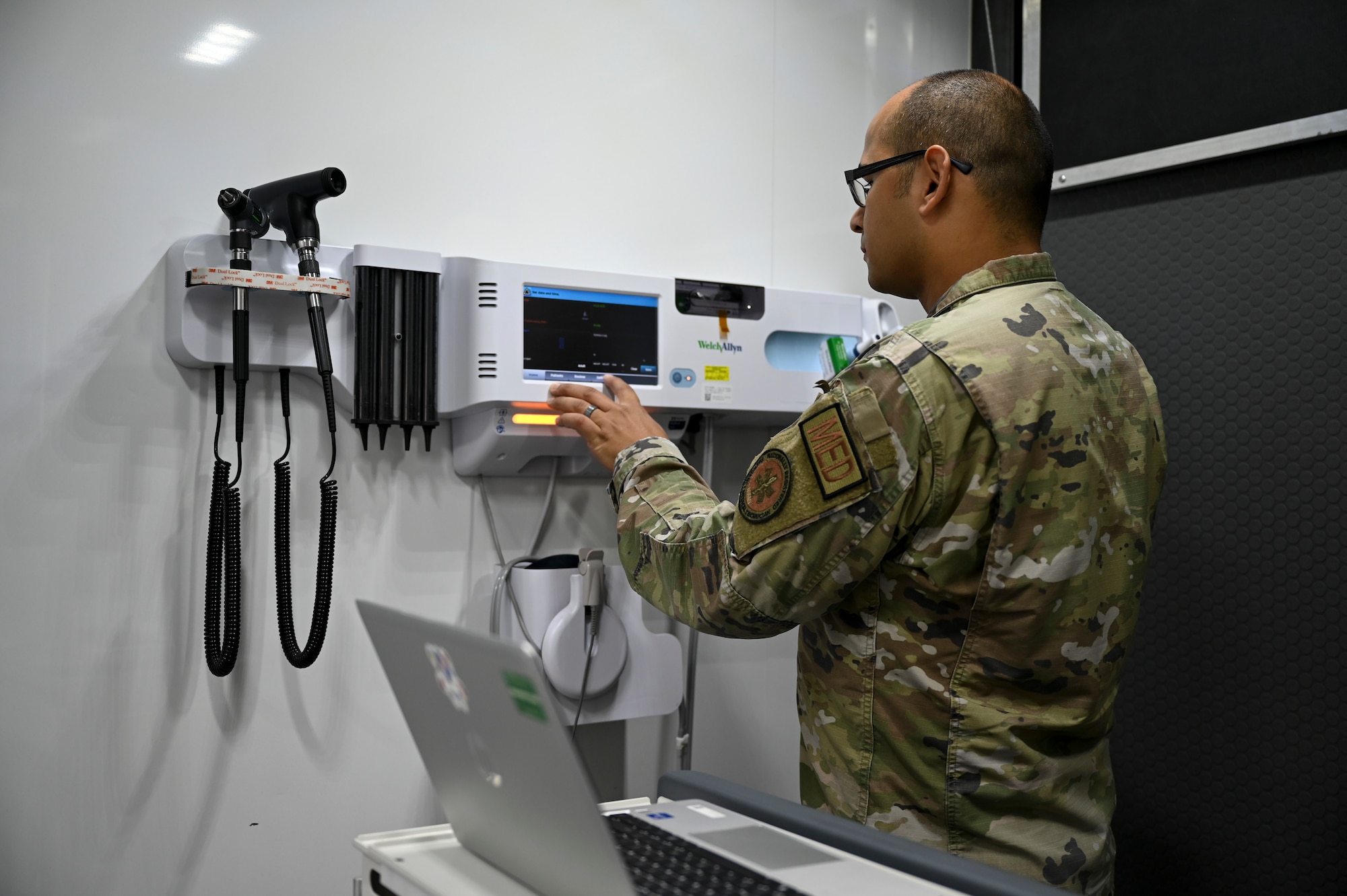 A man uses a blood pressure machine.