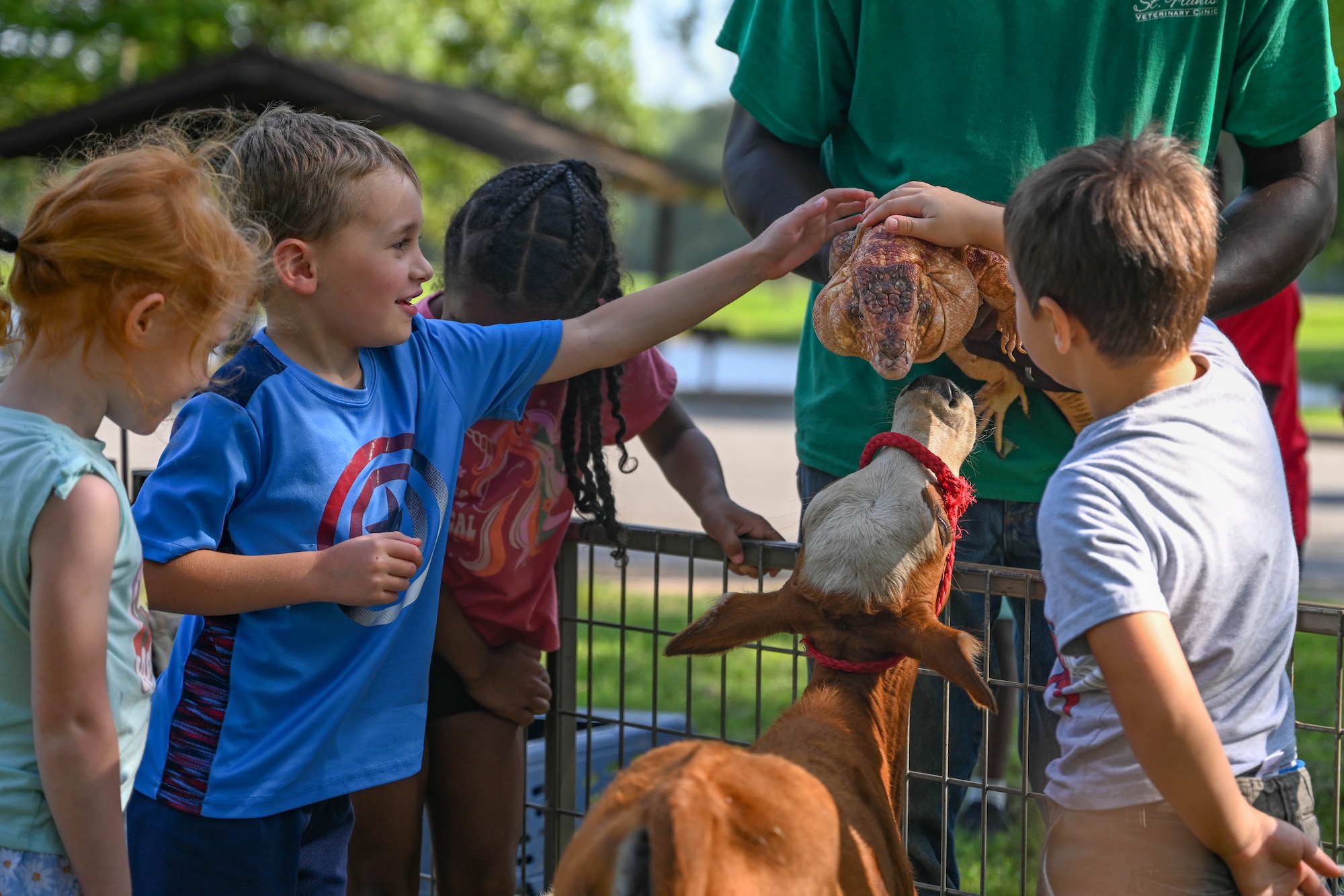 Children pet a lizard