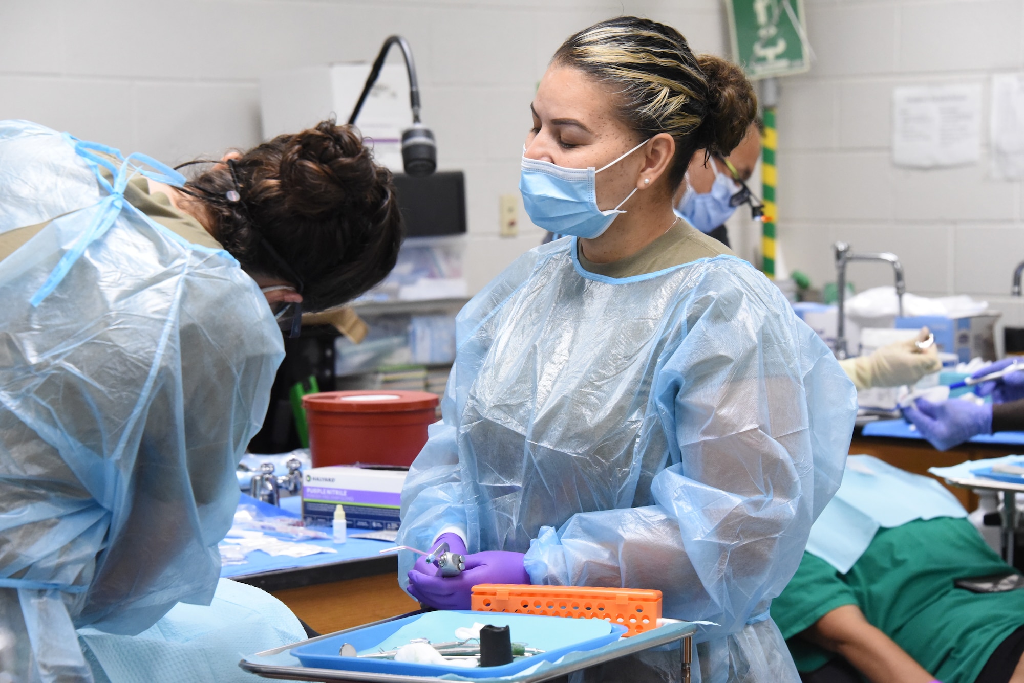 U.S. Air National Guard Master Sgt. Jessica Martinez, a 185th Air Refueling Wing dental assistant, helps provide dental services to a patient.